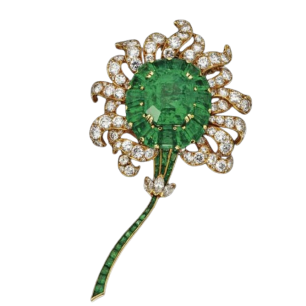 A brooch made of emeralds, diamonds, and gold.