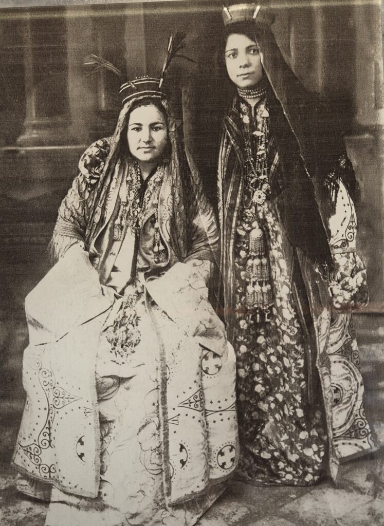 Old photo of two ladies wearing traditional Uzbek jewelry.