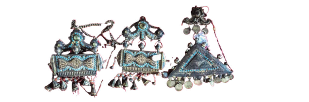 Amulet holders, used as a talisman, are made of silver, turquoise, and fiber.