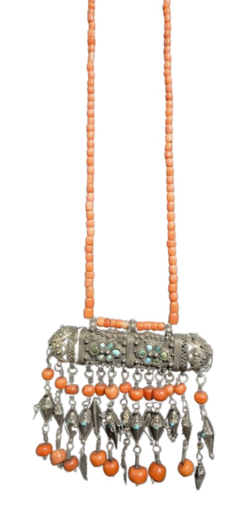 A necklace amulet, made of silver, coral and turquoise.